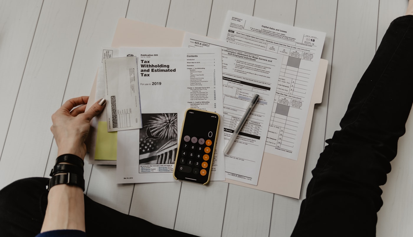 Accounting documents, calculator and financial reports on a desk