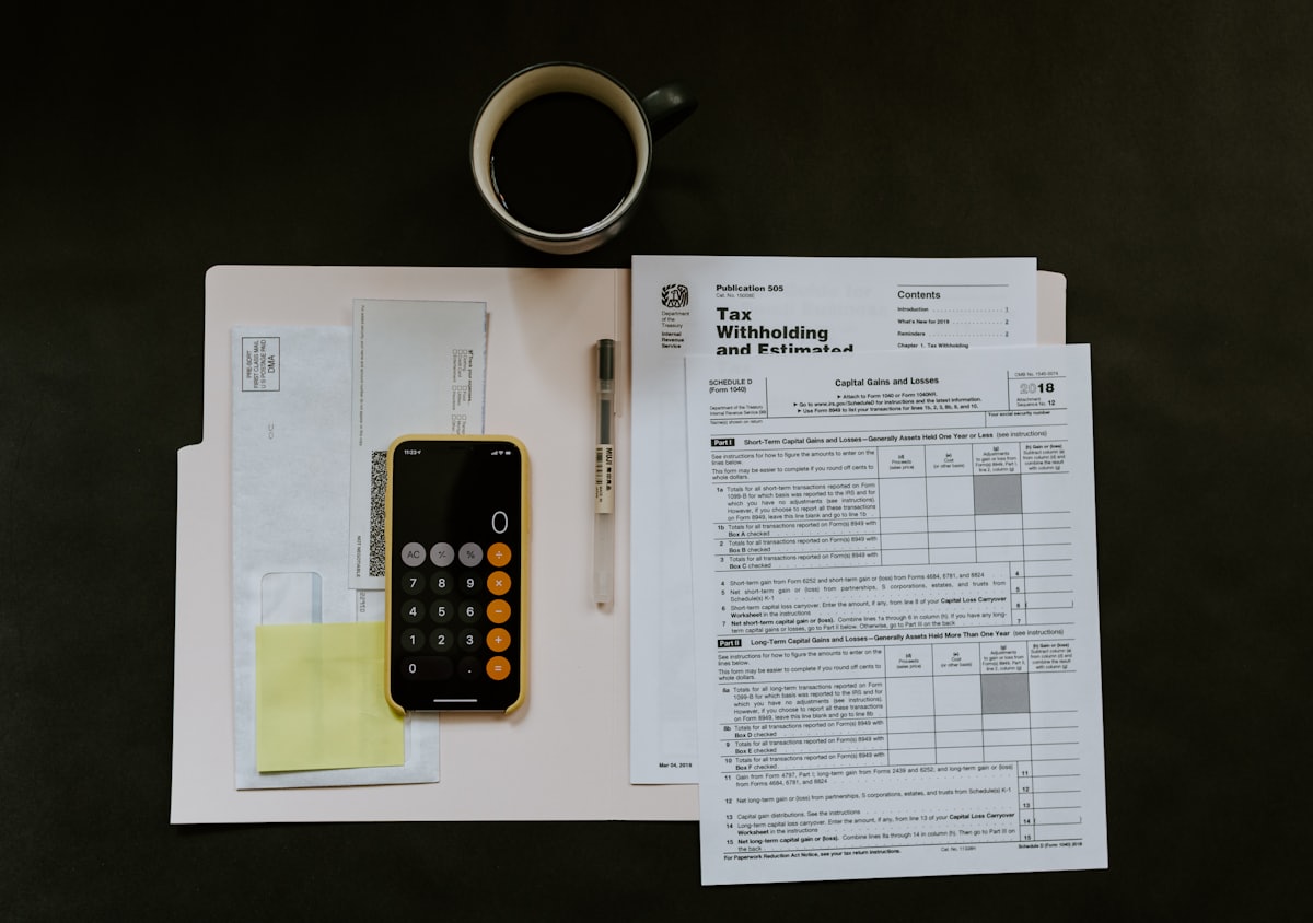 Accountant reviewing monthly bookkeeping records and receipts at a desk