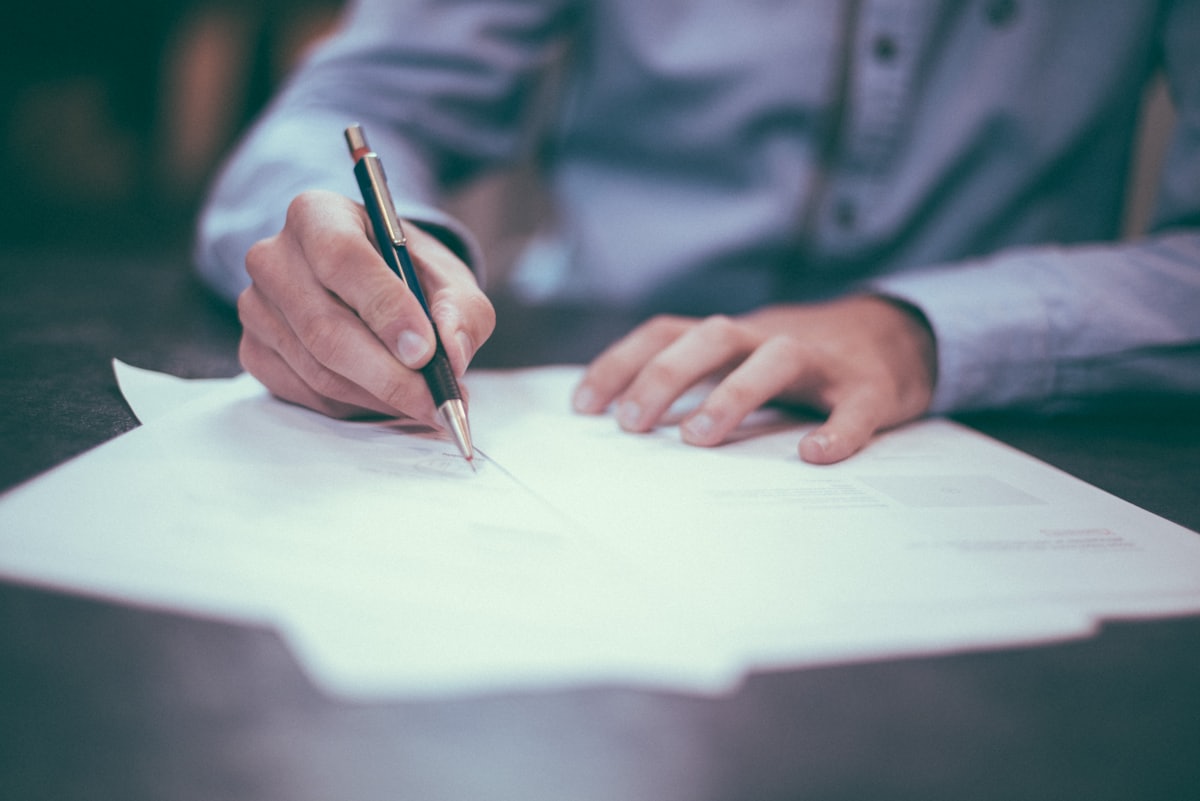 Person reviewing personal tax documents and notes at home